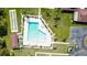 Aerial view of a sparkling community pool with bocce ball court, lounge chairs, and lush landscaping at 2260 Oak Neck Rd # B, Clearwater, FL 33763