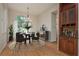 Bright dining room with hardwood floors, arched window, and stylish décor creating an inviting atmosphere at 2270 Barbara Dr, Clearwater, FL 33764