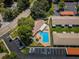 Aerial view of community pool with ample parking, lounging chairs, and meticulously maintained landscaping at 2448 Enterprise Rd # 5, Clearwater, FL 33763