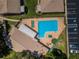 An aerial view of the community pool with lounge chairs, green space, and ample parking at 2448 Enterprise Rd # 5, Clearwater, FL 33763