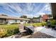 Beautiful backyard with lush landscaping, green lawn, patio, and nearby building at 2448 Enterprise Rd # 5, Clearwater, FL 33763