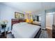 Cozy bedroom features a king bed, hardwood floors, ample closet space, and modern lighting at 2448 Enterprise Rd # 5, Clearwater, FL 33763
