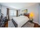 Comfortable bedroom boasts a king bed, modern decor, hardwood floors, and natural light at 2448 Enterprise Rd # 5, Clearwater, FL 33763