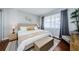 Bright bedroom featuring a king bed, hardwood floors, natural lighting, and modern furniture at 2448 Enterprise Rd # 5, Clearwater, FL 33763