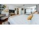 Bright bedroom features a king bed, modern decor, hardwood floors, and closet at 2448 Enterprise Rd # 5, Clearwater, FL 33763