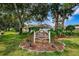 Welcoming Villas at Countryside sign nestled among lush greenery and mature trees at 2448 Enterprise Rd # 5, Clearwater, FL 33763