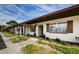 Exterior view of the home featuring charming landscaping and brick accents around the windows at 2448 Enterprise Rd # 5, Clearwater, FL 33763