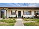 Inviting front entrance with charming landscaping and brick accents around the windows at 2448 Enterprise Rd # 5, Clearwater, FL 33763