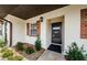 Close up of front entrance featuring a black front door and brick accents at 2448 Enterprise Rd # 5, Clearwater, FL 33763