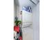 Laundry room features stacked washer and dryer with shelving for supplies at 2448 Enterprise Rd # 5, Clearwater, FL 33763