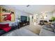 Spacious living room with comfortable seating, tile floors, and view of the dining area and kitchen at 2448 Enterprise Rd # 5, Clearwater, FL 33763