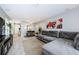 Open-concept living space featuring a spacious sectional sofa, tile floors, and dining area at 2448 Enterprise Rd # 5, Clearwater, FL 33763