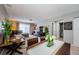 Open-concept living room with a gray sofa, large windows, and a view of the dining area at 2448 Enterprise Rd # 5, Clearwater, FL 33763