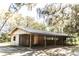 Exterior shot of an equestrian barn with a rustic aesthetic and ample storage space at 26348 Crooked Tree Ln, Brooksville, FL 34602