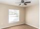 Bedroom with neutral walls, carpet flooring, and a window with blinds at 26348 Crooked Tree Ln, Brooksville, FL 34602