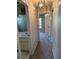 Hallway view of bathroom and bedroom with carpet flooring at 26348 Crooked Tree Ln, Brooksville, FL 34602