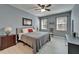 Cozy bedroom with gray walls, wood-look floors, and ceiling fan provides natural light at 3019 Old Fulton Pl, Brandon, FL 33510