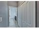 Hallway featuring closet and bathroom with marble floors and a dark wood vanity at 3019 Old Fulton Pl, Brandon, FL 33510