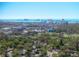 An aerial view of a neighborhood with lush trees, manicured lawns, nearby golf course, and a red pin showing the home's location at 325 Orangeview Ave, Clearwater, FL 33755