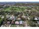 An aerial view of a neighborhood with lush trees, manicured lawns, a pool, and a red pin showing the home's location at 325 Orangeview Ave, Clearwater, FL 33755