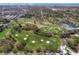 Expansive aerial view of a lush golf course with mature trees and distant city skyline at 325 Orangeview Ave, Clearwater, FL 33755