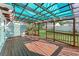 Inviting back deck featuring a shaded pergola, offering a comfortable outdoor living space with views of the backyard at 325 Orangeview Ave, Clearwater, FL 33755
