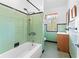 Bathroom featuring a shower, bathtub, sink, and a window providing natural light at 325 Orangeview Ave, Clearwater, FL 33755