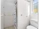 Neat bathroom showcasing a walk-in shower and toilet set against white tiled walls at 325 Orangeview Ave, Clearwater, FL 33755