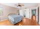 Bedroom features hardwood floors, ceiling fan, closet with mirror, and colorful curtains at 325 Orangeview Ave, Clearwater, FL 33755