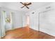 Bedroom with hardwood floors, a ceiling fan, closet, and a window with curtains at 325 Orangeview Ave, Clearwater, FL 33755