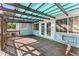 Charming covered deck featuring wood flooring, a pergola roof, and direct access to the backyard through elegant French doors at 325 Orangeview Ave, Clearwater, FL 33755
