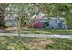 View of the house surrounded by mature trees and beautiful landscaping at 325 Orangeview Ave, Clearwater, FL 33755