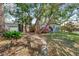 Home showcasing a beautiful yard with mature trees and plants, creating a serene landscape at 325 Orangeview Ave, Clearwater, FL 33755