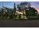 Home with mature trees at dusk at 325 Orangeview Ave, Clearwater, FL 33755
