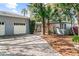 Home with a two-car garage, featuring a beautiful yard and mature trees at 325 Orangeview Ave, Clearwater, FL 33755
