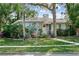 Inviting home featuring a well-maintained lawn, mature landscaping, and a charming front entrance with classic architectural details at 325 Orangeview Ave, Clearwater, FL 33755