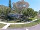A lovely single-story home with mature trees, a well-manicured lawn and a beautiful front yard at 325 Orangeview Ave, Clearwater, FL 33755