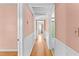 Hallway featuring hardwood floors, trim molding, with doorways leading to different rooms at 325 Orangeview Ave, Clearwater, FL 33755
