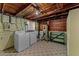 Utility area with a modern washer and dryer, wooden ceilings, and a utility sink for added convenience at 325 Orangeview Ave, Clearwater, FL 33755