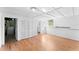 Clean, bright room with hardwood floors, a utility closet, and built-in storage shelving at 325 Orangeview Ave, Clearwater, FL 33755