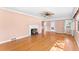 Bright living room featuring hardwood floors, a decorative fireplace, and natural light, offering a cozy and inviting atmosphere at 325 Orangeview Ave, Clearwater, FL 33755