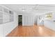 Bright room with hardwood floors, built-in shelving and storage closet in neutral decor at 325 Orangeview Ave, Clearwater, FL 33755