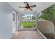 Enclosed porch featuring tiled flooring, a ceiling fan, and views of the backyard at 325 Orangeview Ave, Clearwater, FL 33755