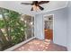 Cozy porch with tiled flooring, a view of foliage, and an entrance to the home's interior at 325 Orangeview Ave, Clearwater, FL 33755