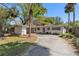 Well-maintained single-story home with an attached carport, a charming front yard, and a paved driveway at 404 S Barbara Ln, Tampa, FL 33609