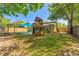 Spacious backyard with mature trees and a fun wooden playset at 408 Valencia Park Dr, Seffner, FL 33584