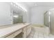 Bathroom featuring a built-in vanity, oversized mirror, and a glass shower next to a soaking tub at 408 Valencia Park Dr, Seffner, FL 33584