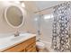 Bathroom featuring a wood vanity, mirror, and a shower-tub combo at 408 Valencia Park Dr, Seffner, FL 33584