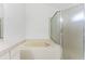 Bathroom showing a jetted soaking tub, shower, and storage with tiled flooring in a well-lit space at 408 Valencia Park Dr, Seffner, FL 33584