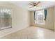 Bright bedroom featuring neutral walls, tile flooring, and large windows at 408 Valencia Park Dr, Seffner, FL 33584